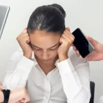 Overwhelmed professional surrounded by devices, struggling of not getting enough patients online.