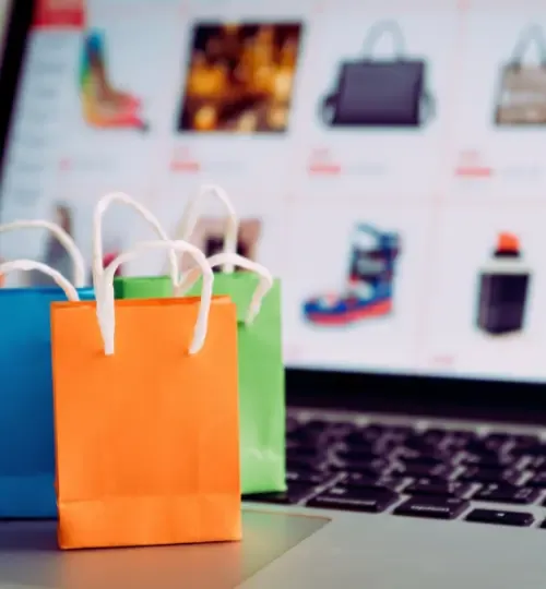 Online shopping and e-commerce illustration with shopping bags and laptop