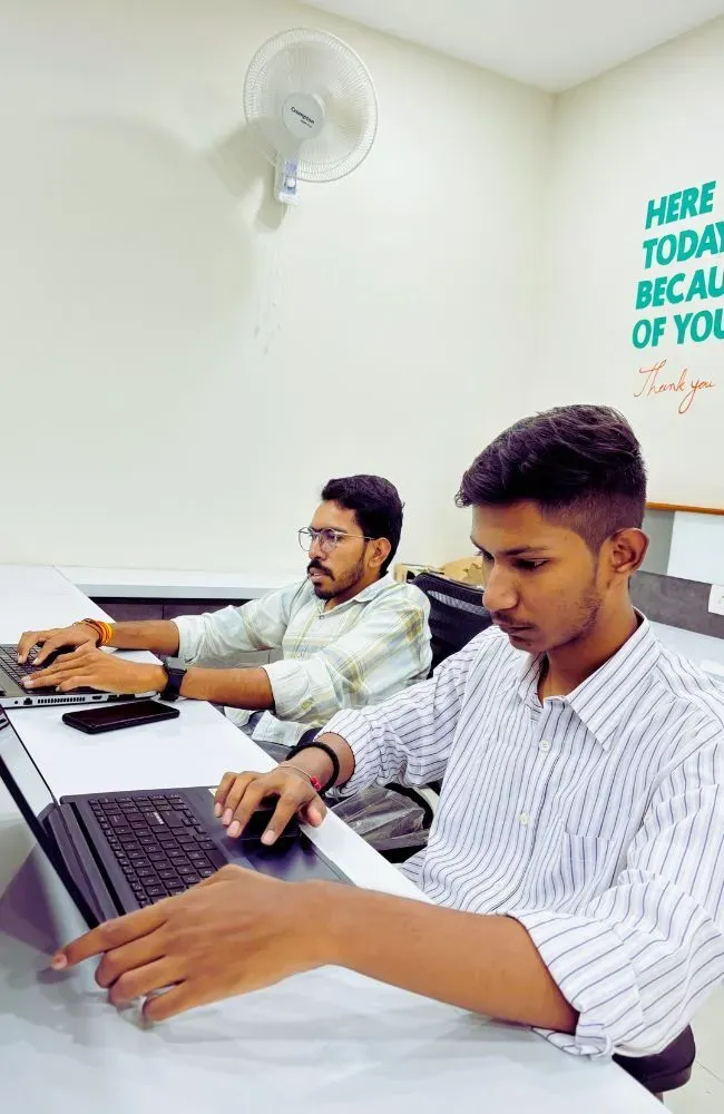 Adept Digitals employees working at their desks in the office