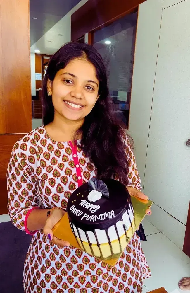 Adept Digitals employee celebrating Guru Purnima with a cake